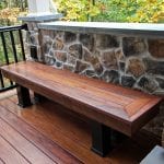 deck bench with stone wall