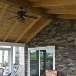 sliding porch door surrounded by grey stone wall