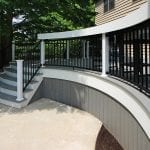 Brook - Pebble gray Trex deck with curved steps and bar bumpout