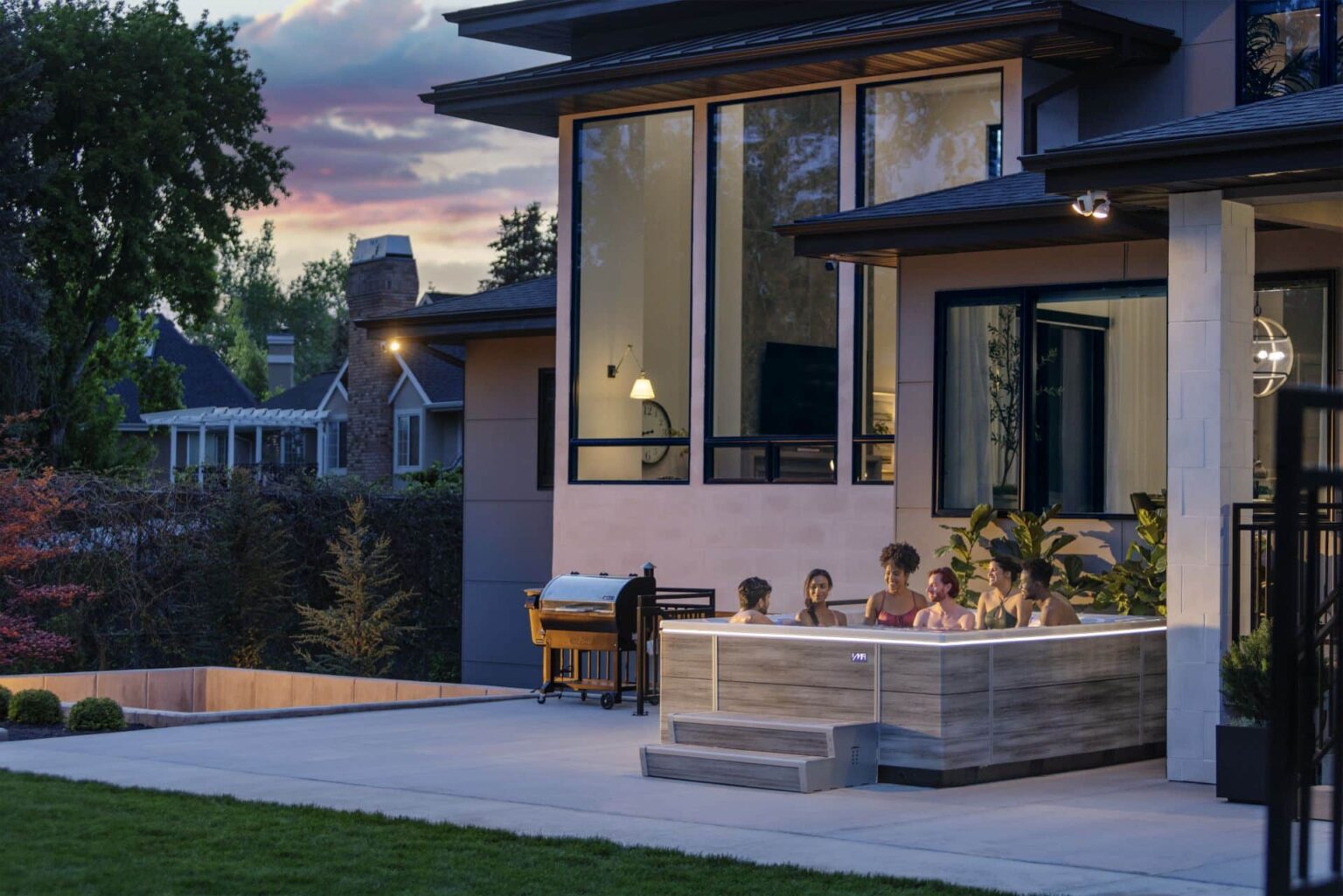 people relaxing in a hot tub at twilight