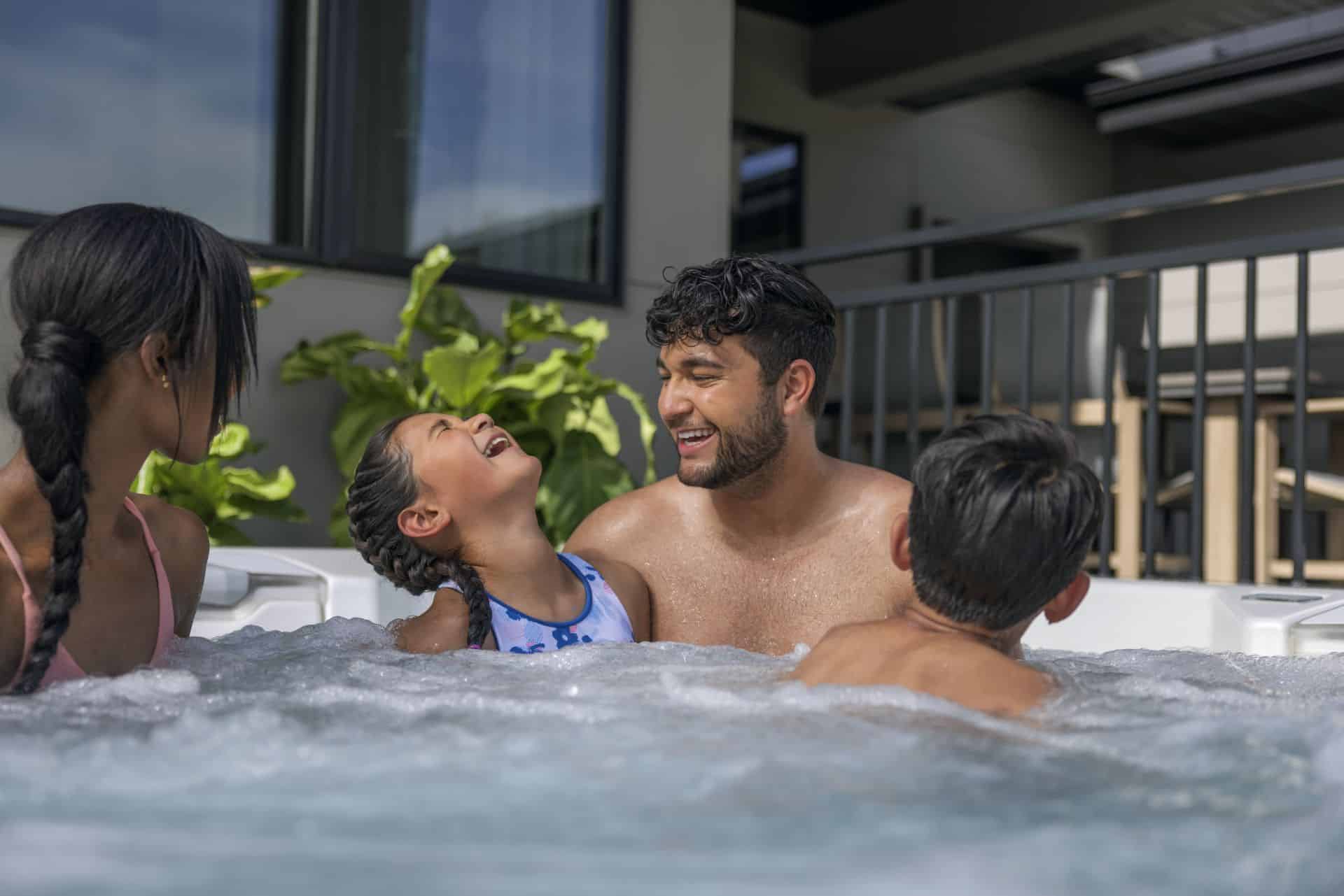 family relaxing in a hot tub