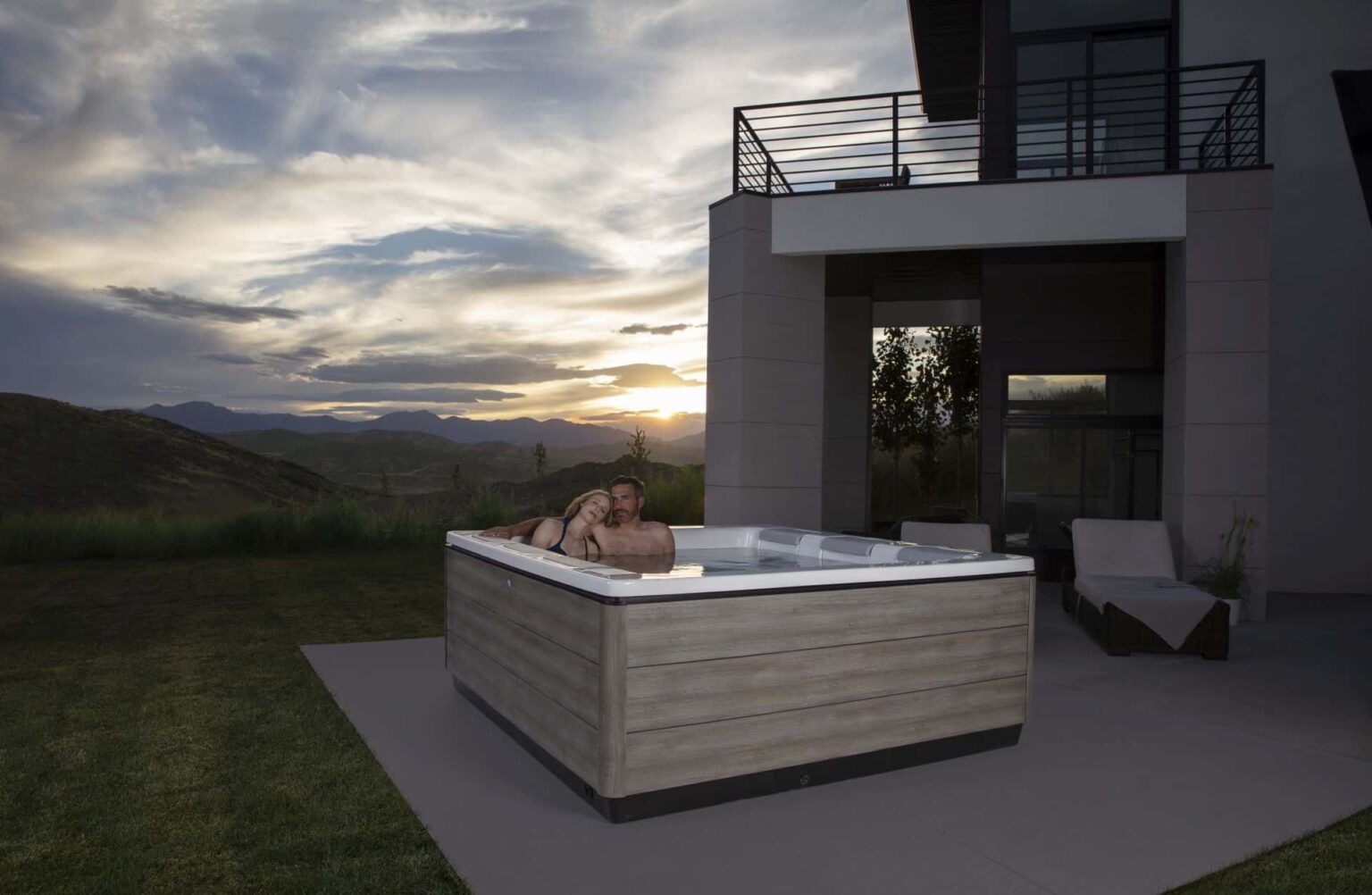 romantic couple in a hot tub at nightfall