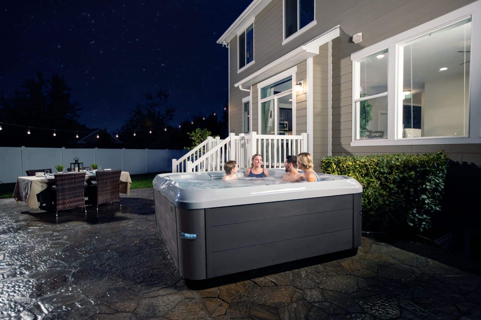 people enjoying an outdoor hot tub at night