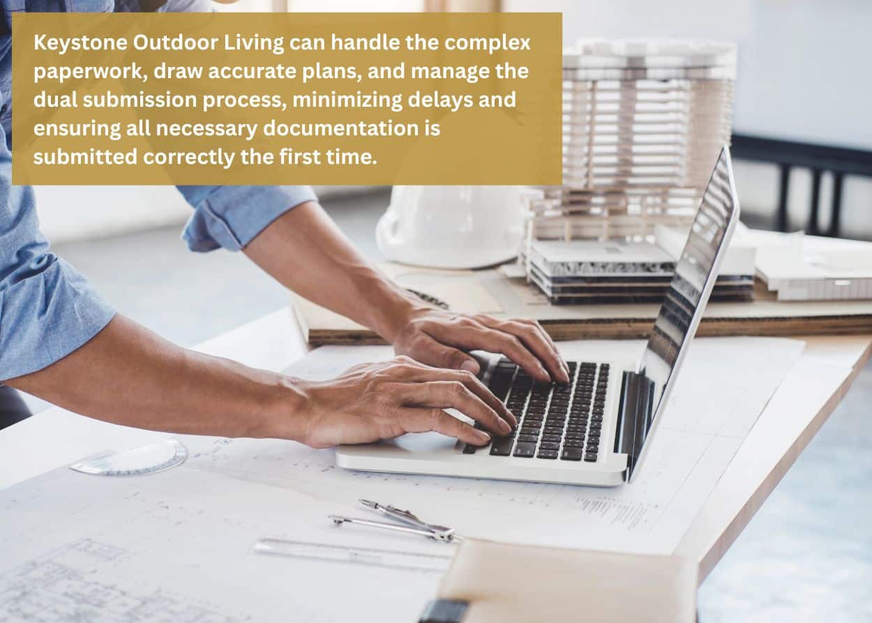 Deck design professional reviewing construction plans and permits at a desk, highlighting full-service deck design and permitting support in Derry Township, PA. Caption: Keystone Outdoor Living can handle the complex paperwork, draw accurate plans, and manage the dual submission process, minimizing delays and ensuring all necessary documentation is submitted correctly the first time.