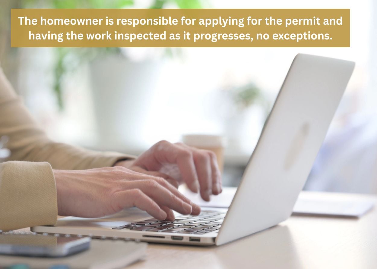 Person completing a deck permit application online before building a custom deck in Monroe Township, PA.