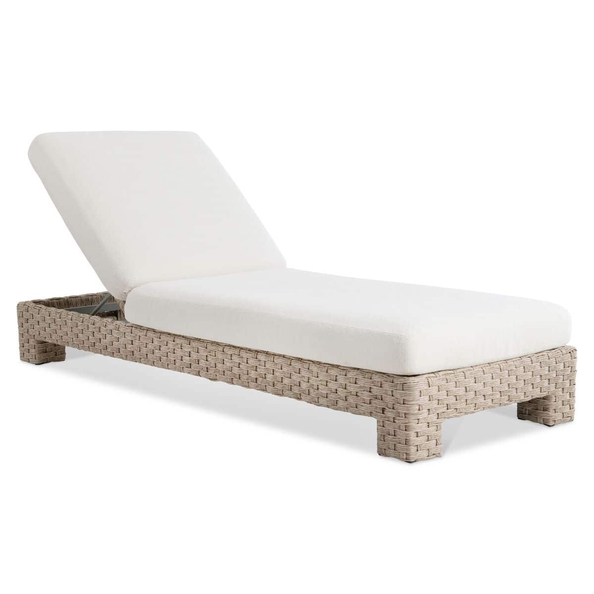 A wicker chaise lounge with an adjustable white cushion, set against a plain white background. The lounger has a simple, modern design.