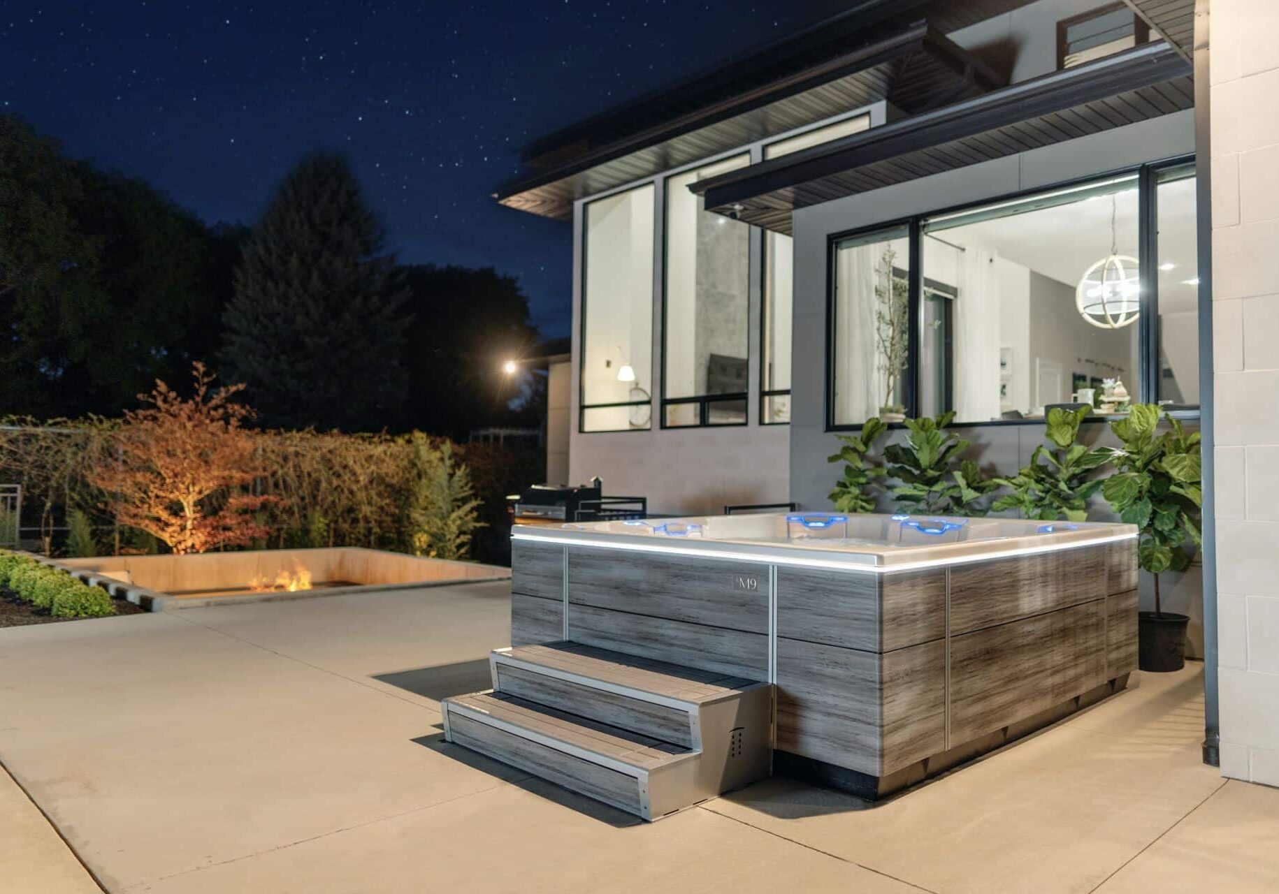 m-series-spas-hot-tubs4 hot tub at nighttime on a back patio