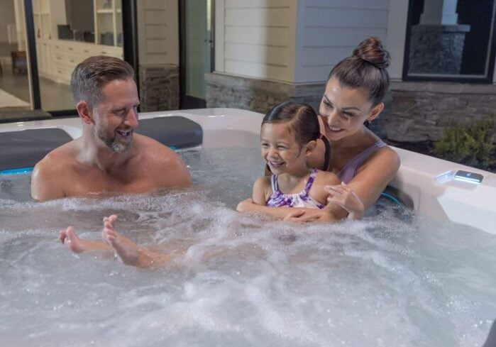 family of three relaxing in a hot tub