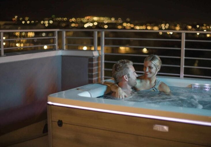 romantic couple in a hot tub at night